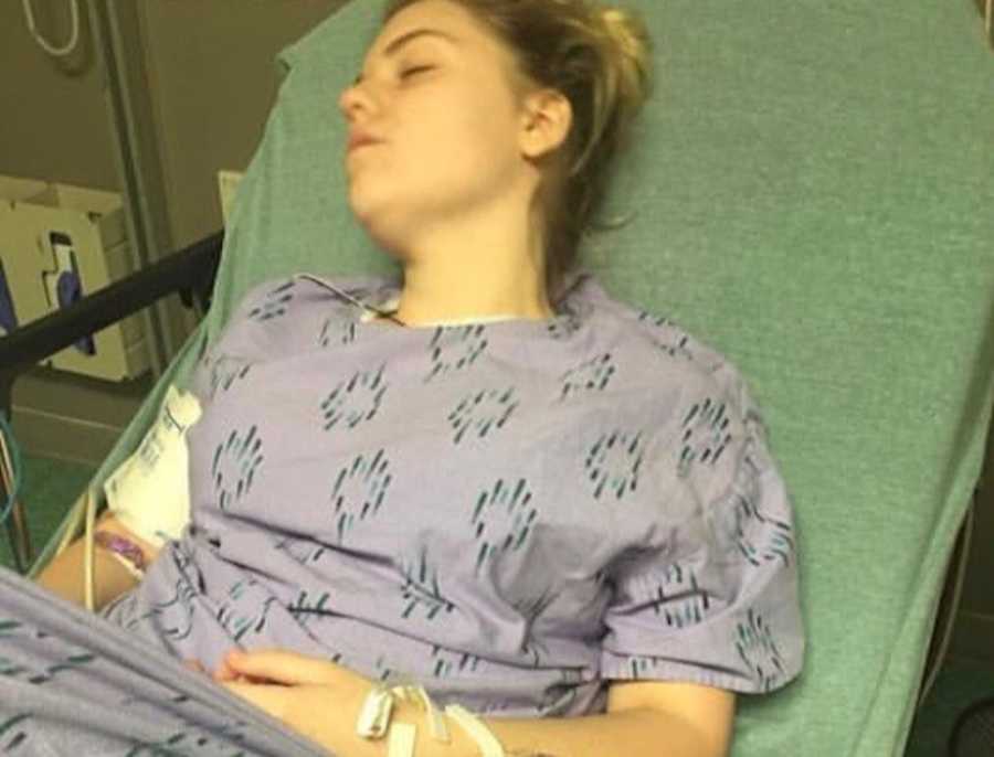 Teen with lupus lying in hospital bed asleep 