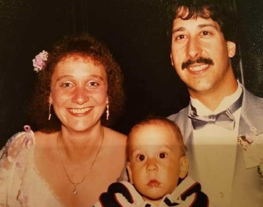 Mother and father smile with birth son who had a sister he had never known about who was put up for adoption