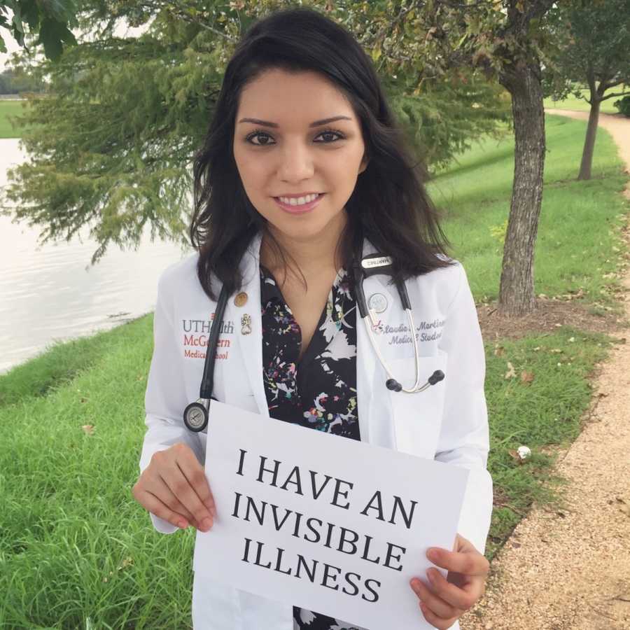 Woman with chiari malformation and who is also a doctor holds up paper saying, "I have an invisible illness"