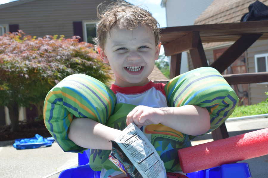 Toddler who almost drown once sits on side of pool with floaties on eating bag of chips