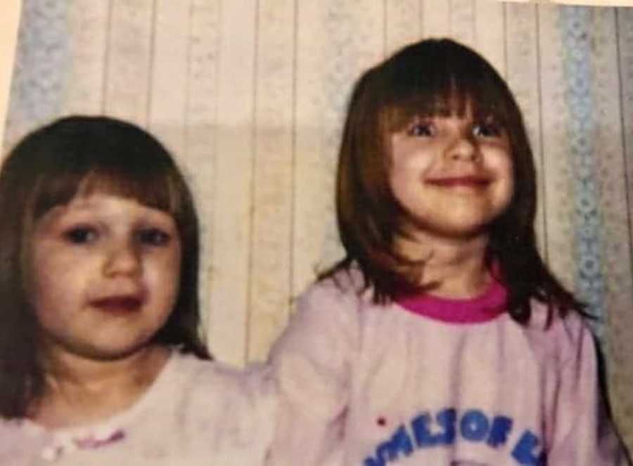 Girl who will one day over dose smiling as a little girl next to her younger sister