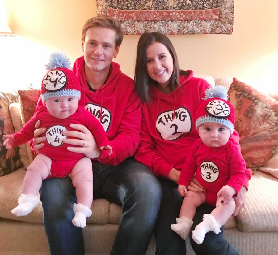 Husband and wife who struggled to get pregnant sit with their twins on their laps