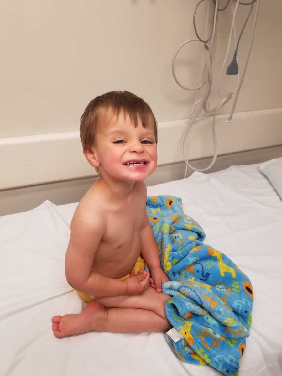 Little boy smiling after receiving surgery to remove part of tumor