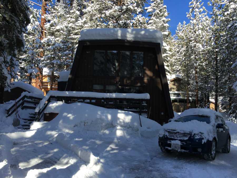 Home covered in snow where woman had to relocate with foster kids due to military husband