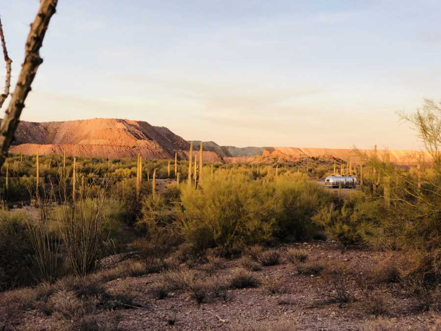 Desert with airstream in background where family of 6 lives traveling the US