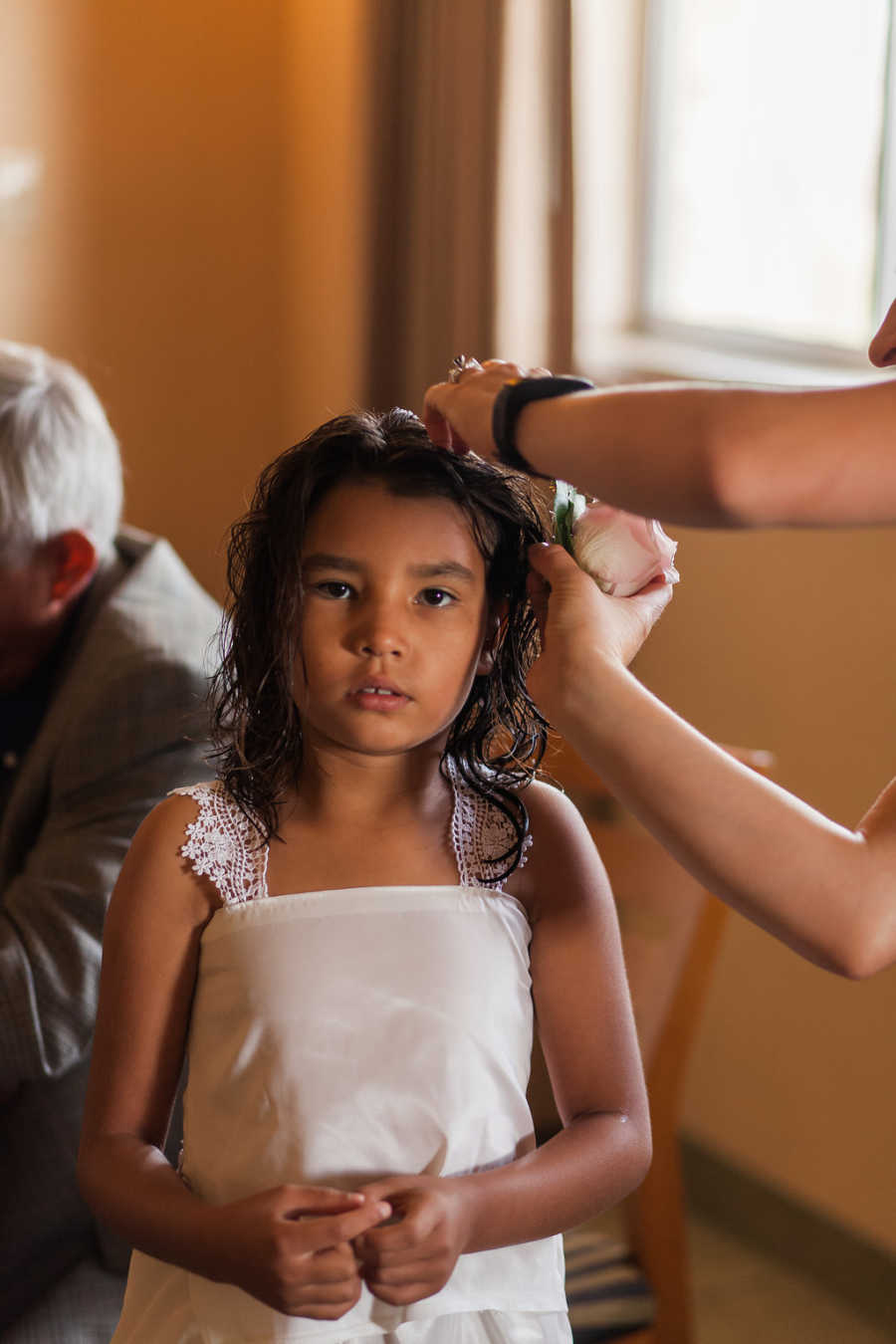 Mother puts rose behind oldest foster daughter's ear for adoption court