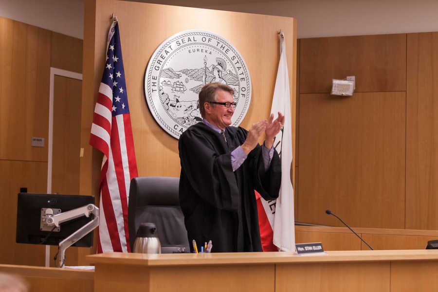 Judge at adoption court stands clapping