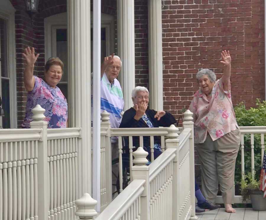 Grandfather and grandmother with dementia wave goodbye to granddaughter who is leaving for college