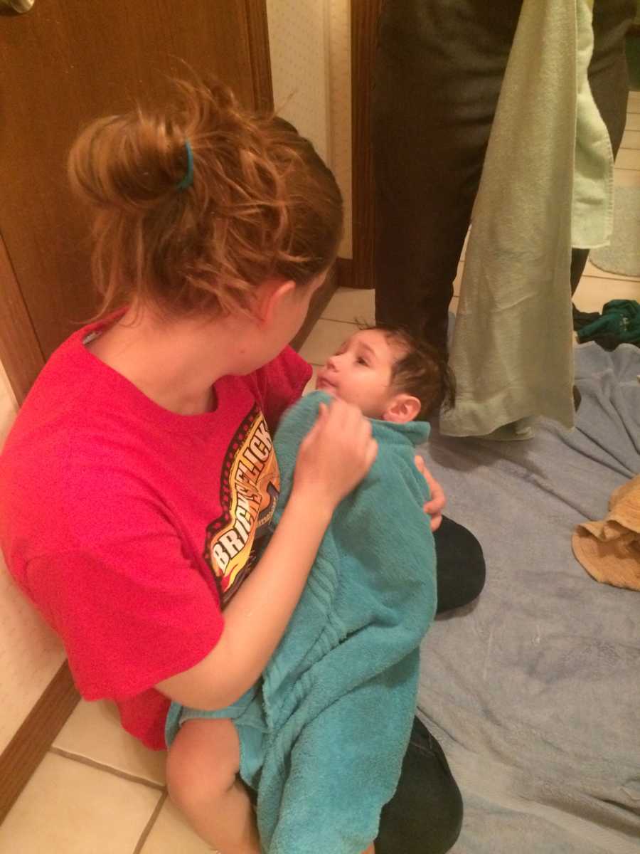 College student sits on bathroom floor holding her late step-moms 2 year old son she is now mother to