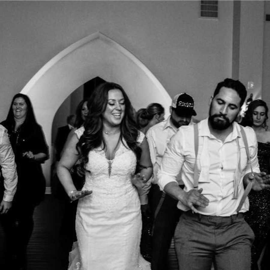 Bride and groom who will later find out he has no sperm dance at wedding reception