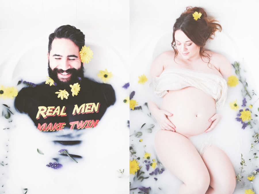 Husband in bath wearing t-shirt saying, "Real men make twins" next to pregnant wife in bathtub for pregnancy shoot