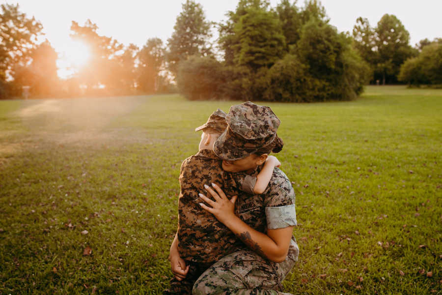 Marine mom comforts her crying daughter during outdoor photoshoot