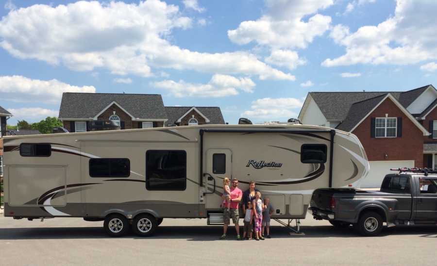 Family of 6 stand in front of airstream that they will travel the United States in