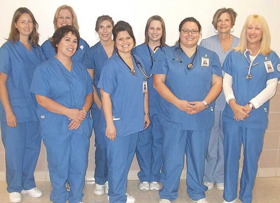 Woman in nursing school stands beside her fellow nursing students