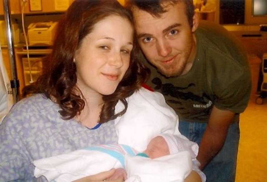 Seventeen year old mother sits in hospital holding newborn beside father of child
