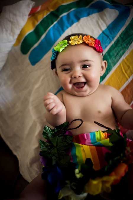 Infant whose mother had trouble conceiving her lays in rainbow tutu and headband