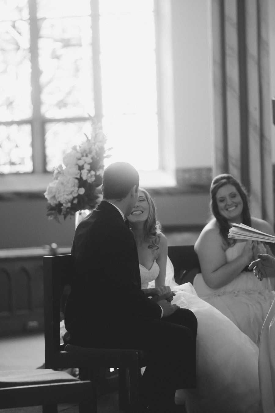 Bride with Ehlers-Danlos Syndrome sits smiling at groom