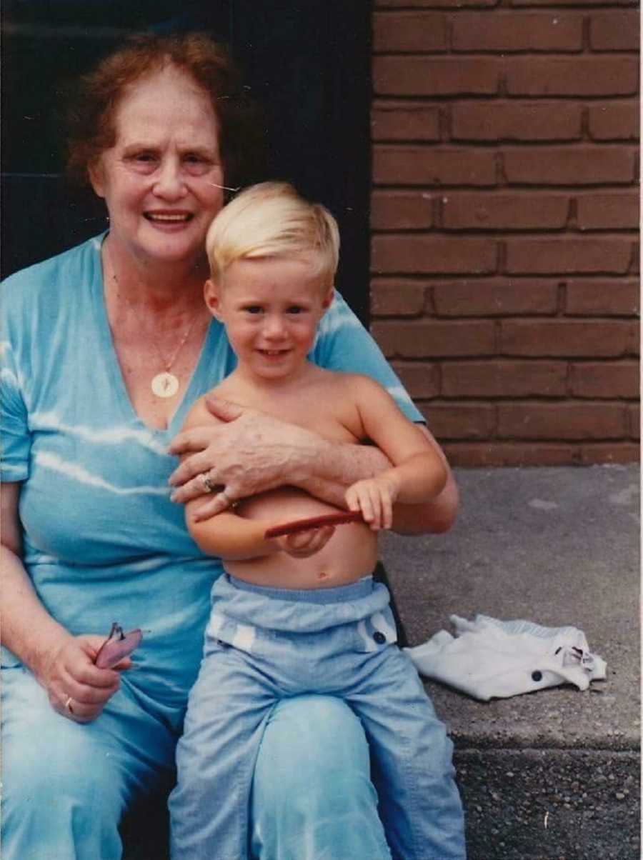 Grandmother who is a holocaust survivor sits with grandson on her lap