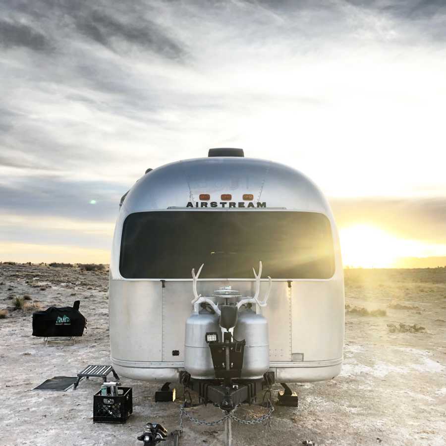 Airstream sitting in desert that is now home to family of 6