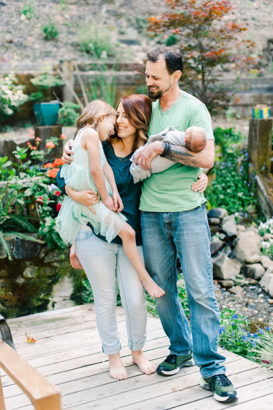Family of four take spring photos together in a garden