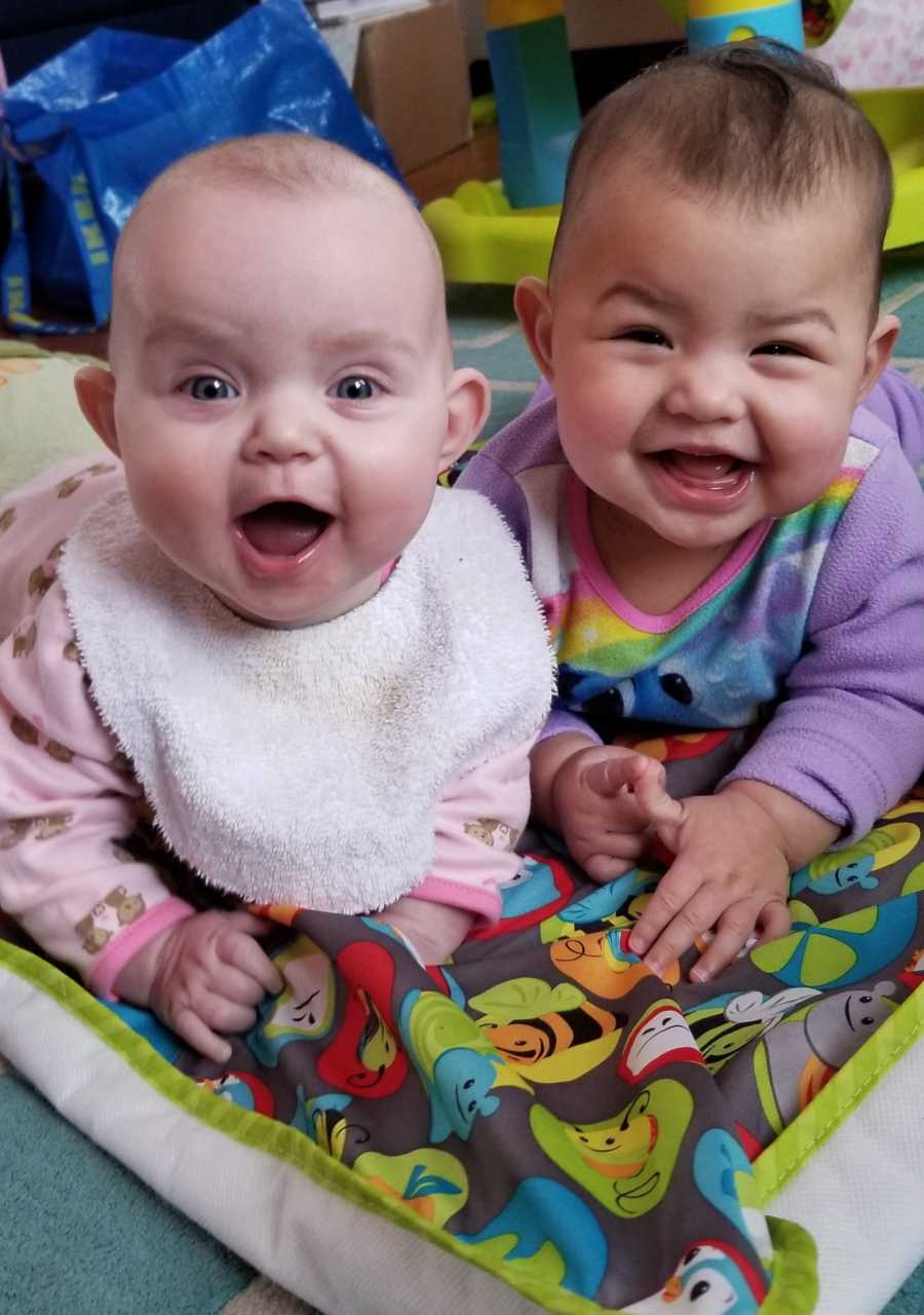 Newborn smiles next to adopted sister parents took in from couple at church