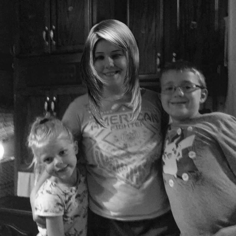Grandmother stands with two grand kids who are the reason she became sober