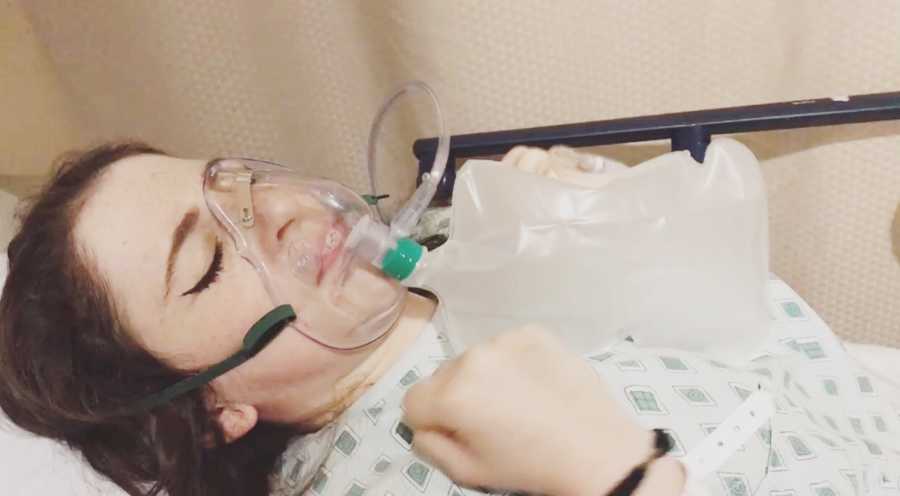Woman with mysterious illness lying in hospital bed with bag of oxygen