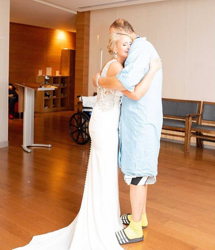 Bride cries while hugging father who is in hospital with pancreatitis