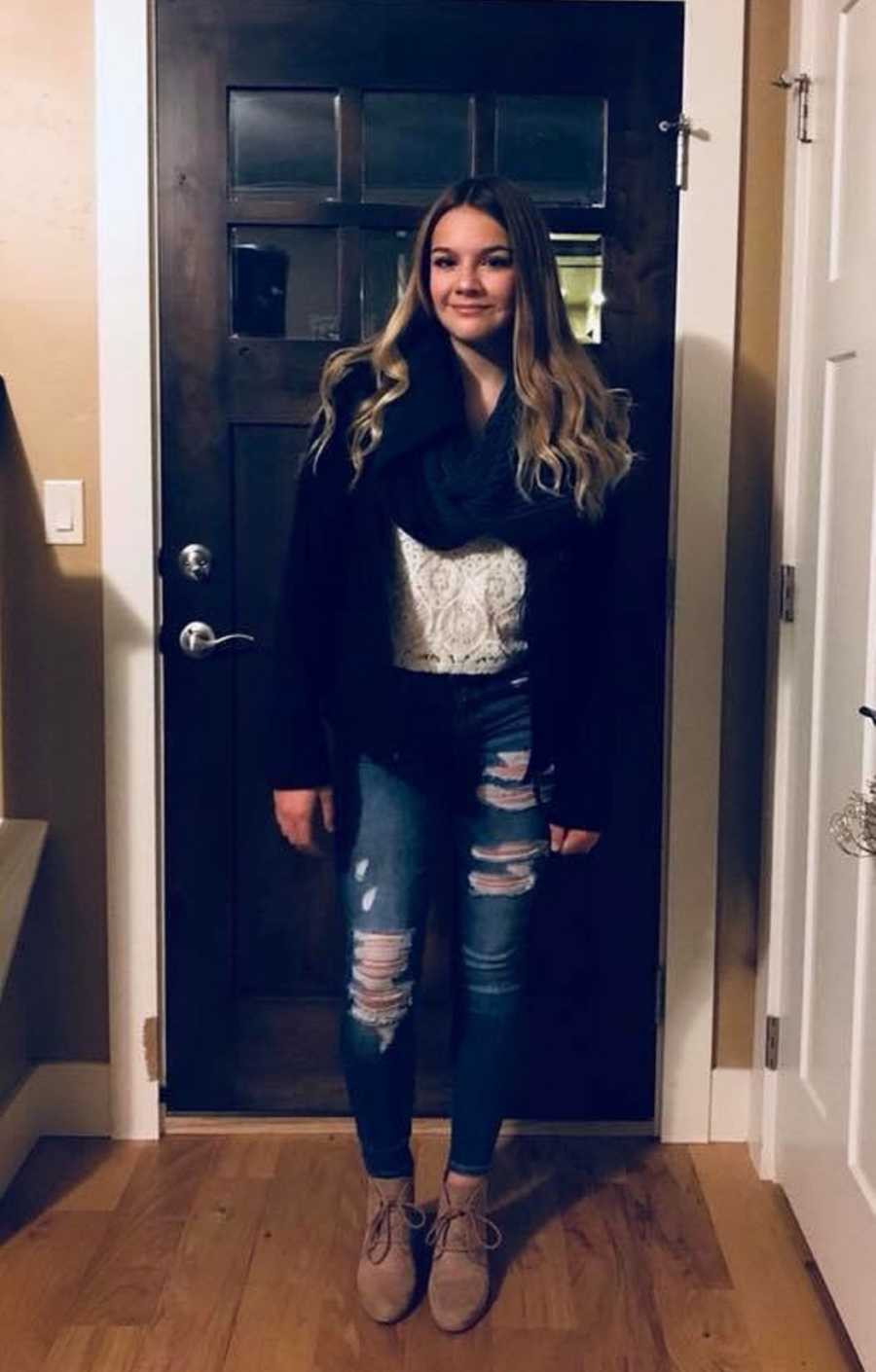  Daughter whose mother tells her what life was like when she was a teen stands smiling in front of front door