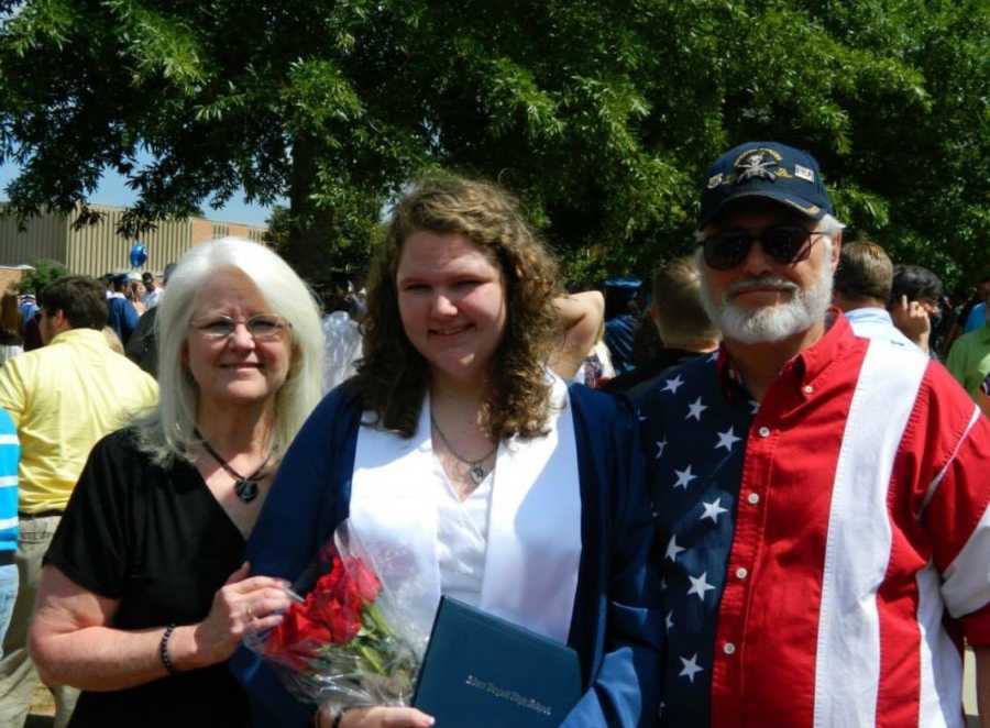 Teen who passed away in car crash stands with parents at graduation