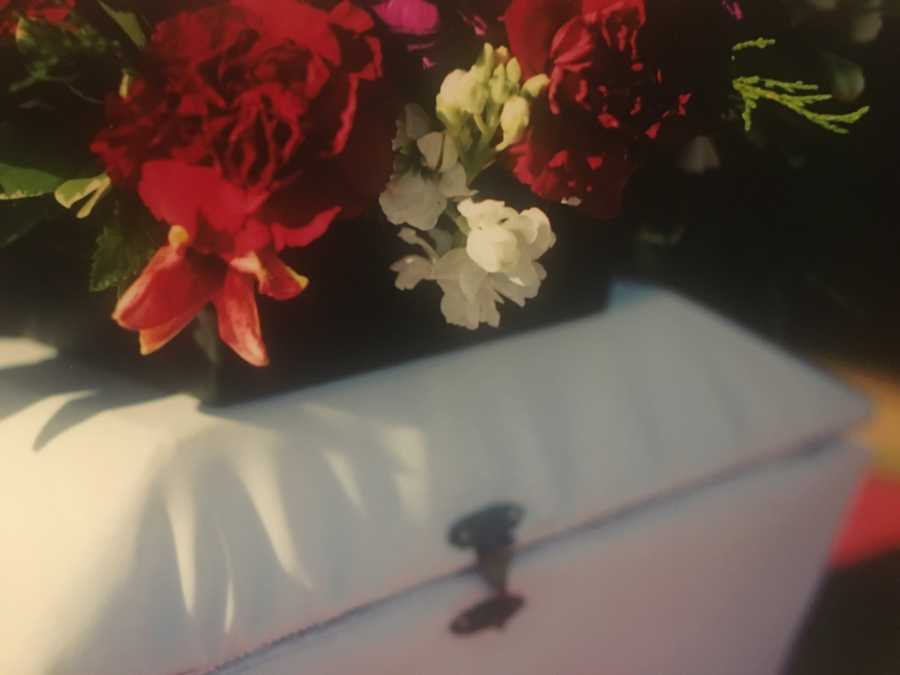 Casket for micro-preemie with flowers on top