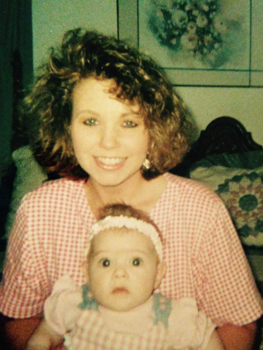 Mother smiling with baby daughter on her lap whose last words to her father will be "shut up"