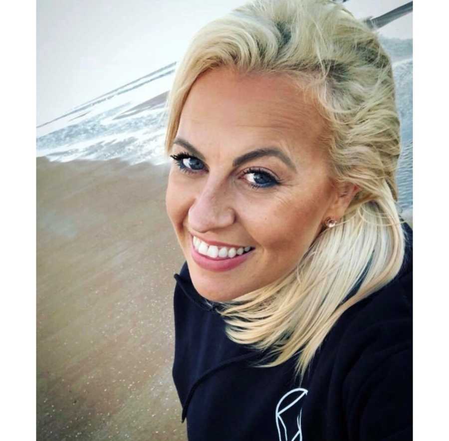 Recovered junkie smiling in selfie while walking on beach