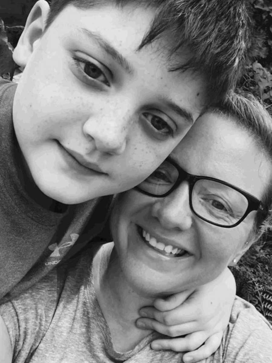 Mother smiling in selfie with young son with autism