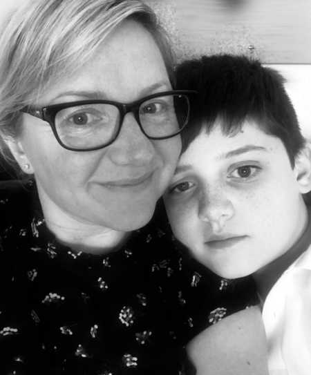 Mother who takes care of her self for sake of her autistic son smiles in selfie with him