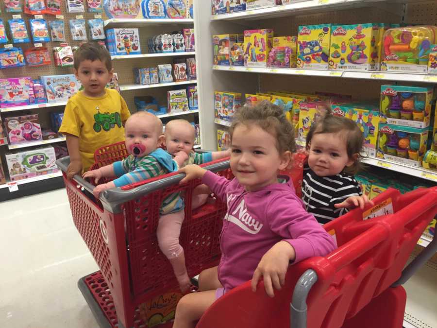 Woman's 5 children sit in Target shopping cart in toy aisle