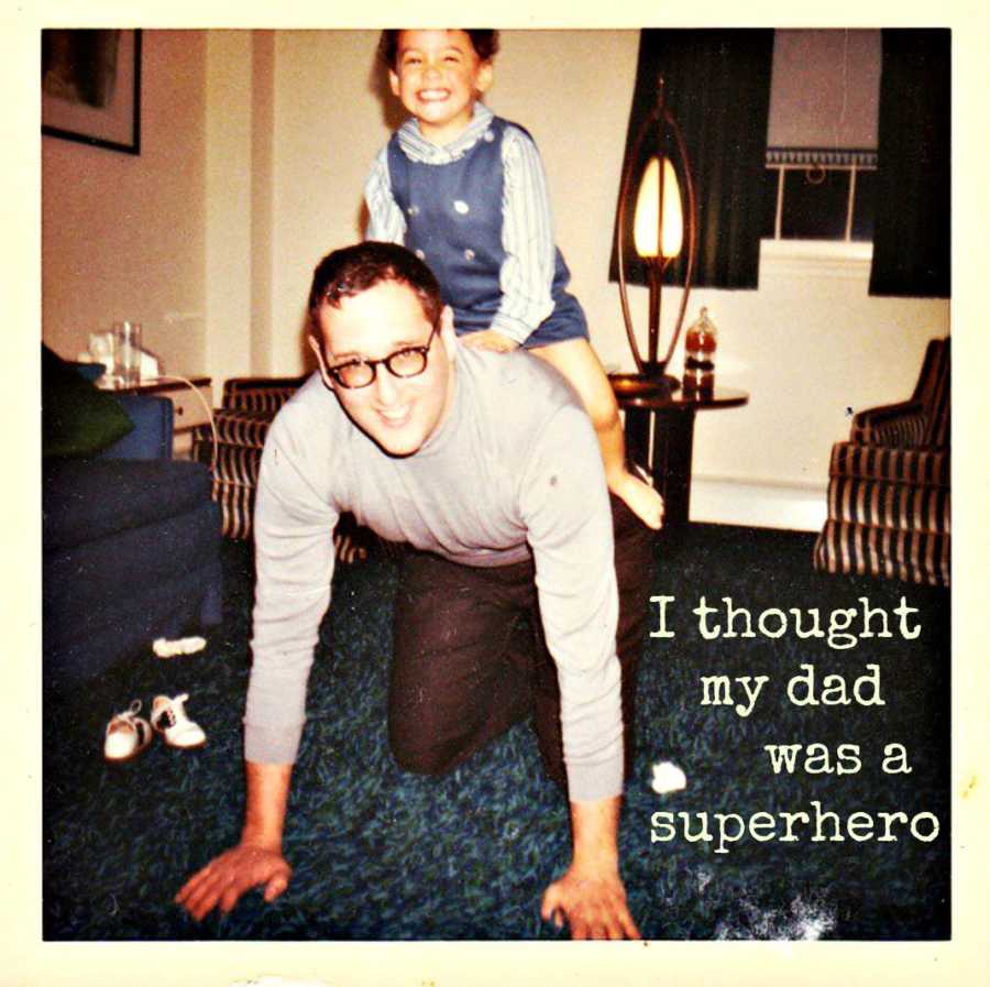 Little boy who is now a father sits on his father's back who on all fours in living room