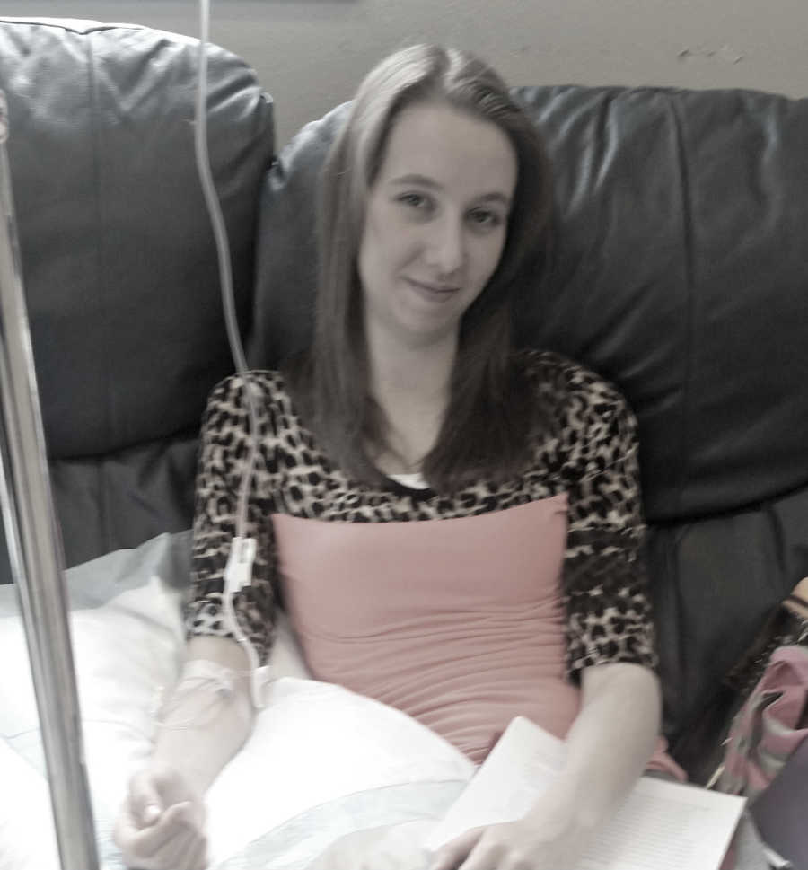 Teen with lyme disease smiles on couch with IV attached to her arm