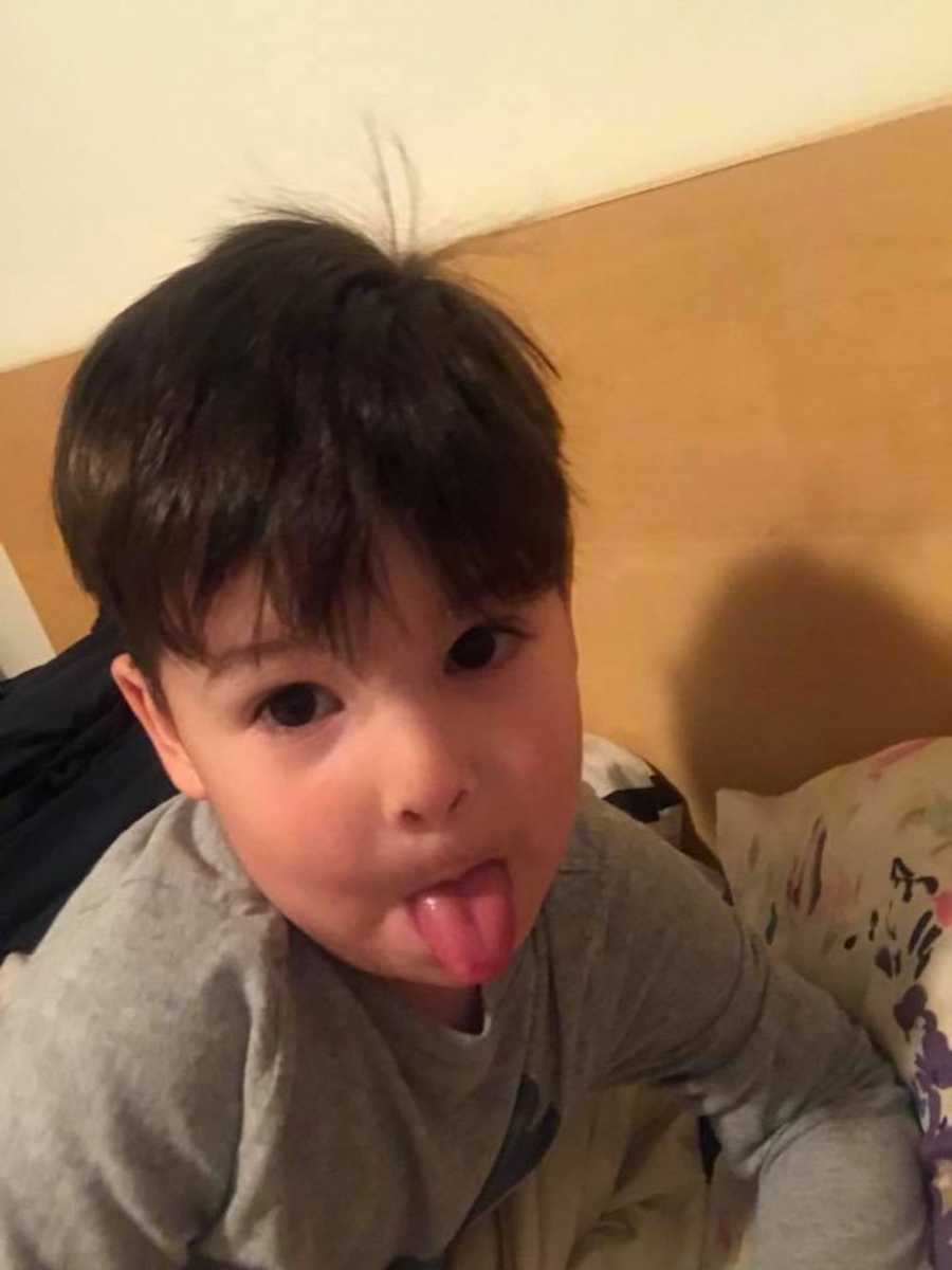 Little boy who wouldn't stop talking in woman's public restroom sits with tongue out