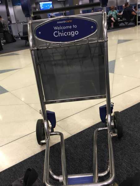 Luggage cart in airport that says, "Welcome to Chicago"