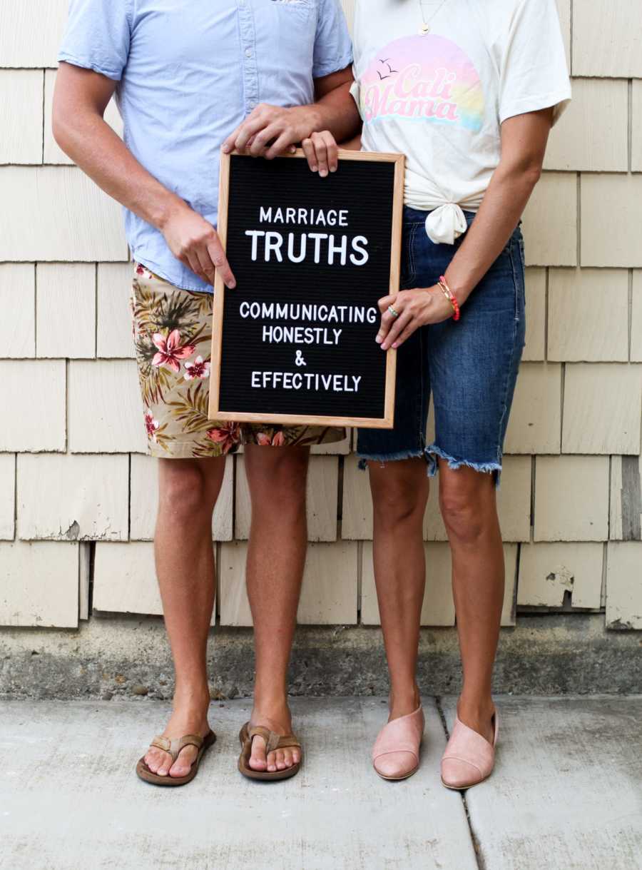 Husband and wife stand holding a sign saying, "Marriage truths communicating honestly and effectively"