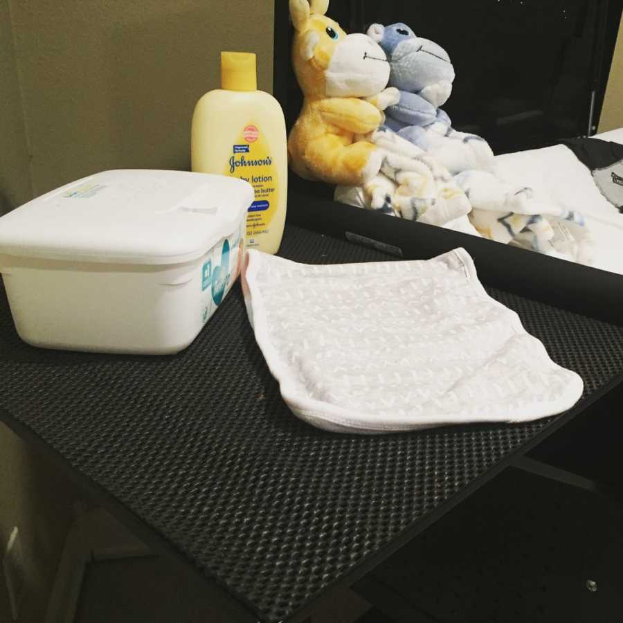 Changing table with blanket, baby wipes, lotion and stuffed animals