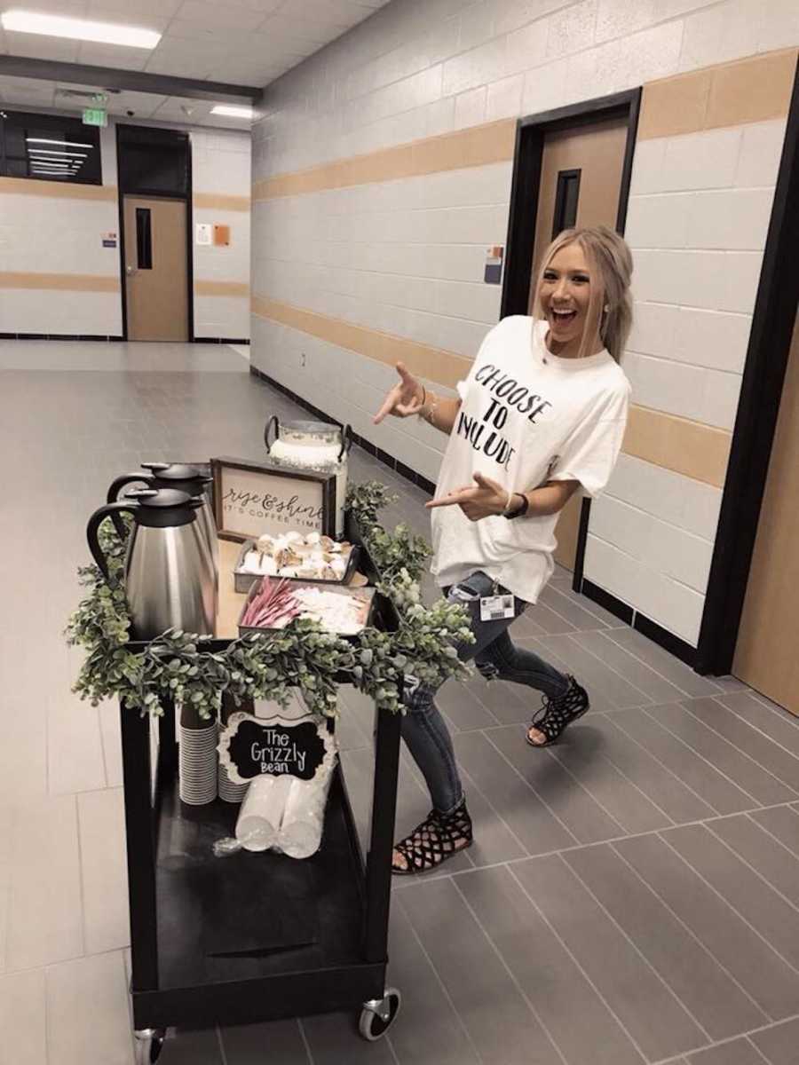 Special education teacher stands next to coffee cart she made for her students to push around school