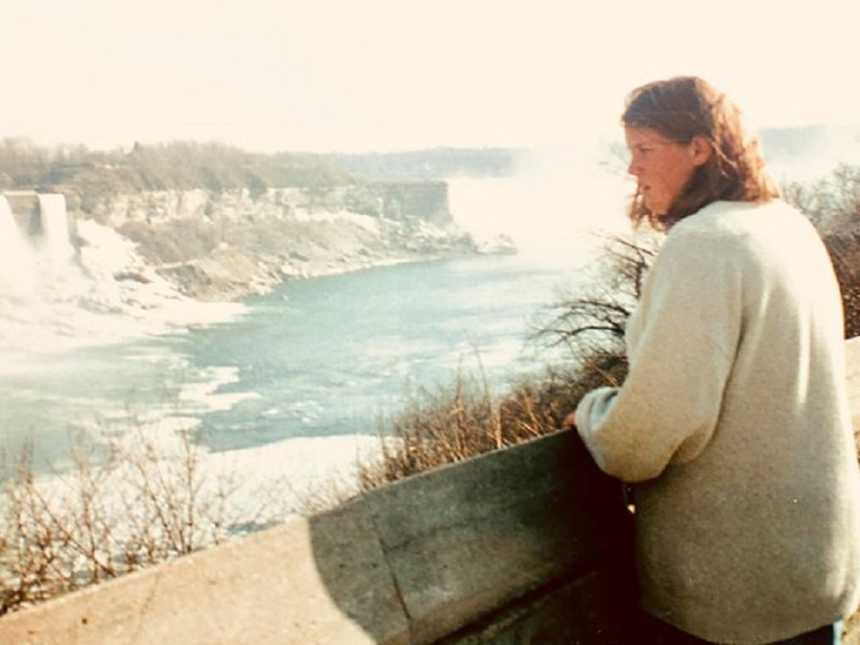 Woman who attempted suicide and failed as a teen looking out at body of water