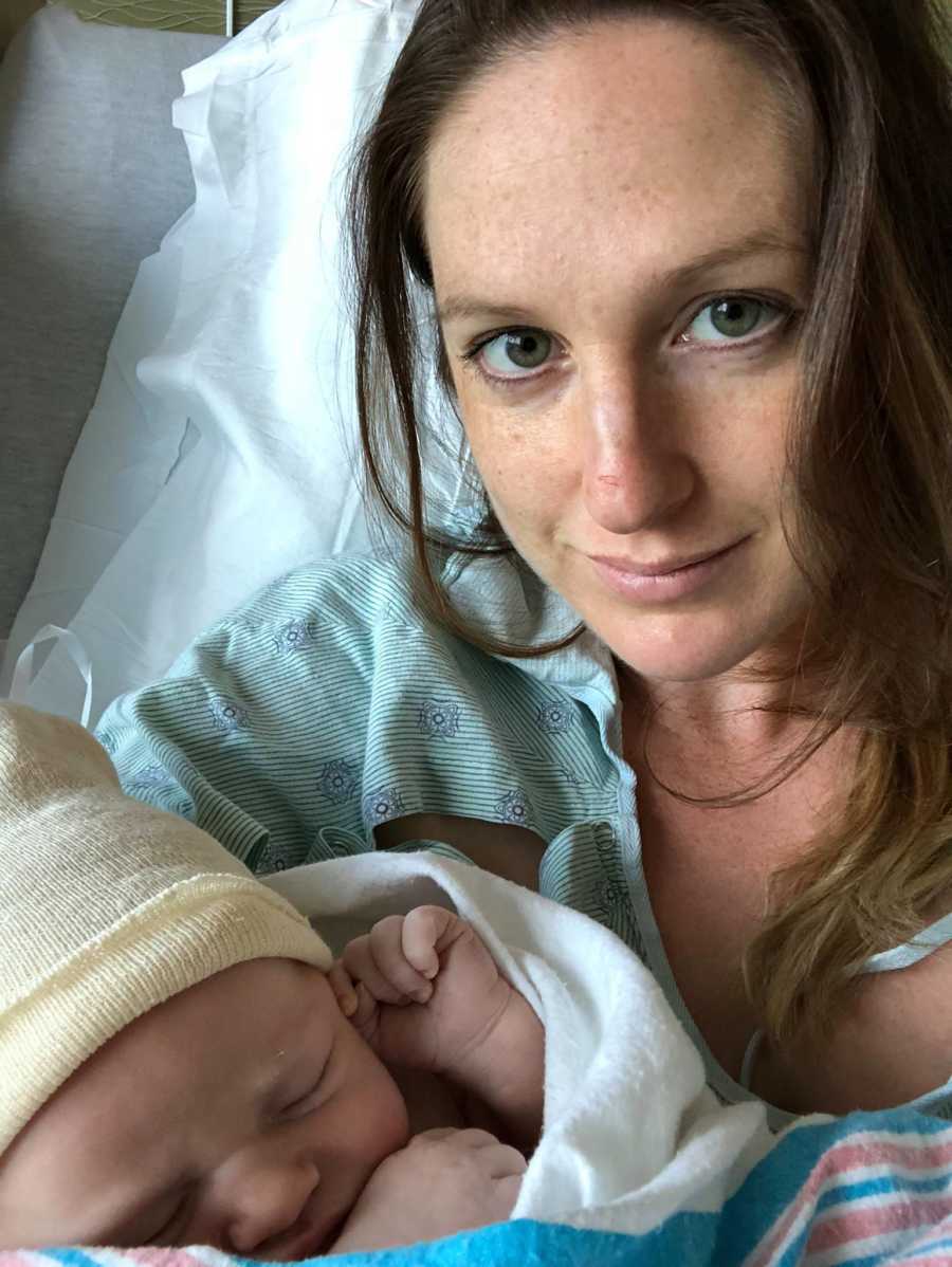 Mother who says women forget what it's like to go through labor smiles in selfie with newborn in hospital bed