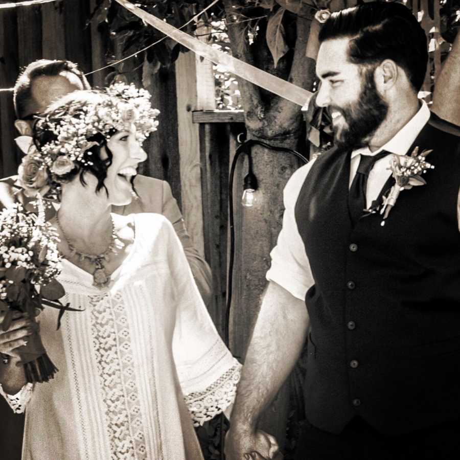 Bride with cancer smiles while looking at groom at wedding ceremony