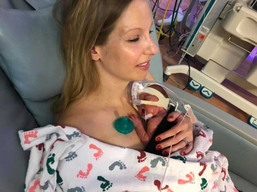 Woman who became pregnant through IVF holds newborn to her bare chest after giving birth