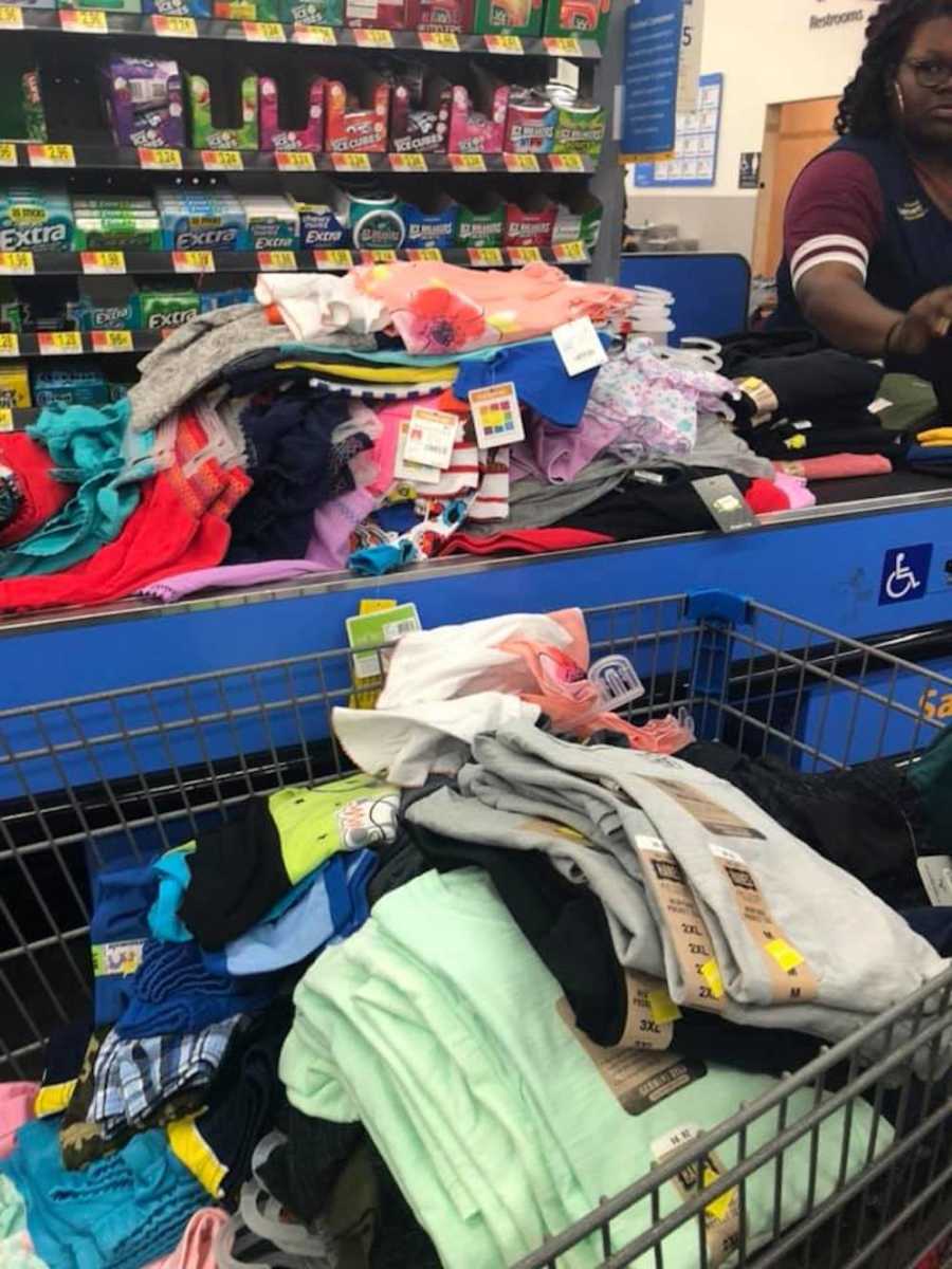 Clothes piled in shopping cart and checkout belt for survivors of Hurricane Florence