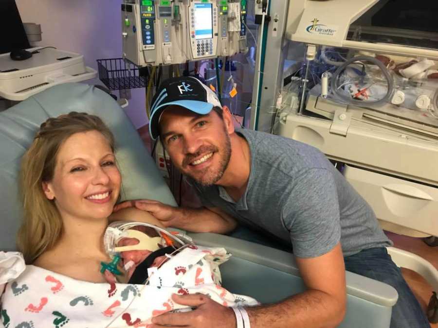 Woman who just gave birth holds newborn conceived through IVF to her chest beside husband