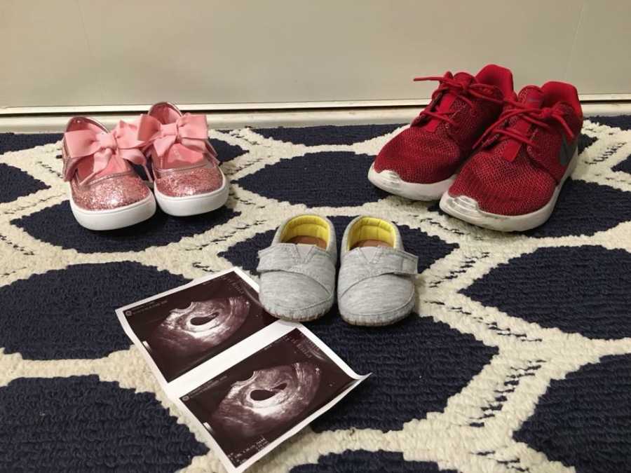 Children's shoes on floor that belong to first born, child who had passed, and child that will soon be born